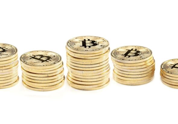 Five piles of Bitcoins lined up together