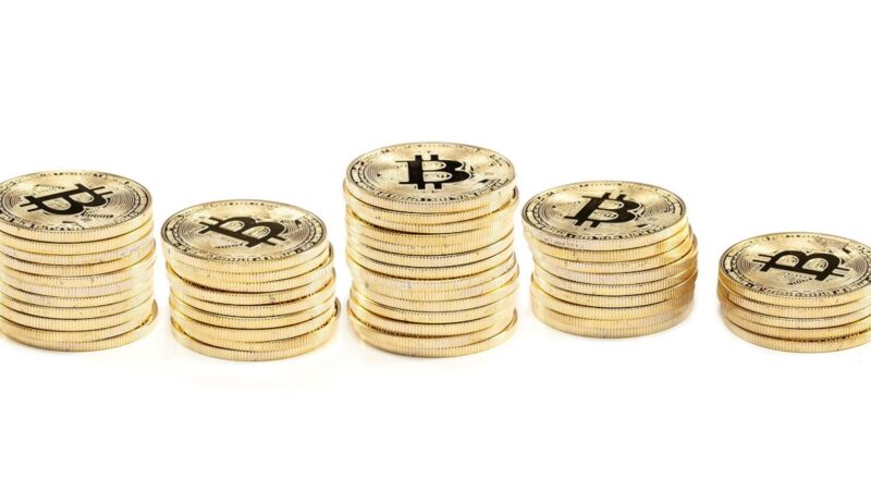 Five piles of Bitcoins lined up together
