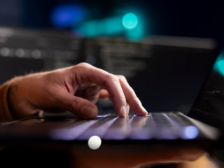 Specialist at a computer shaping a brand with an online casino software solution